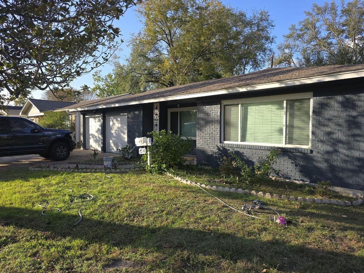 Exterior painting contractors near me repainting a Houston house exterior